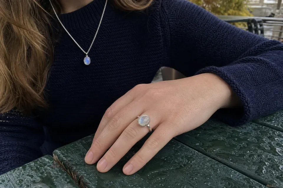 Silver moonstone ring and pendant in soft natural light